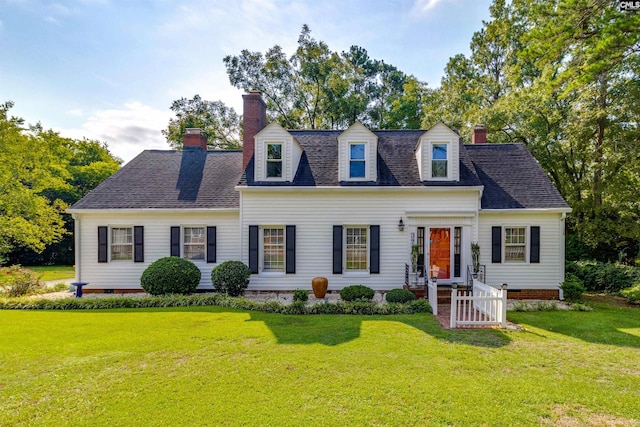 cape cod home with a front lawn