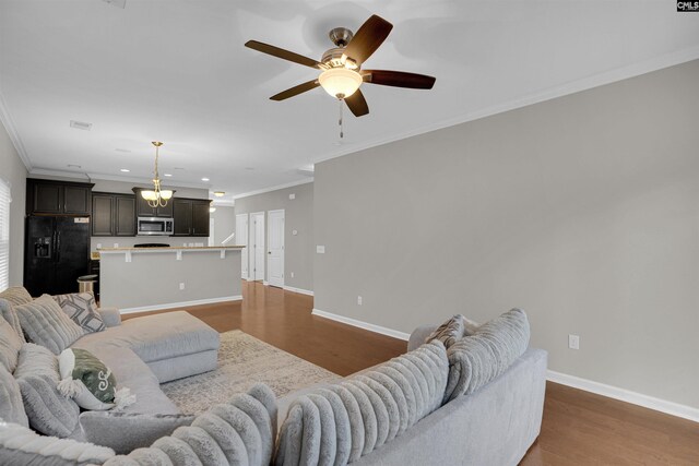 25 Eason Ct, Columbia, SC 29209 - living room featuring crown molding, wood finished floors, baseboards, recessed lighting, and ceiling fan with notable chandelier