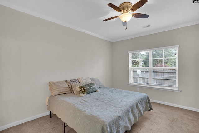 bedroom with crown molding, light carpet, and ceiling fan