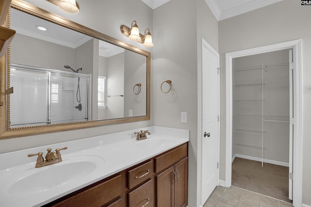 bathroom featuring crown molding, tile patterned flooring, vanity, and an enclosed shower