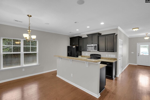 25 Eason Ct, Columbia, SC 29209 - kitchen featuring a breakfast bar area, hardwood / wood-style flooring, baseboards, black appliances, and an inviting chandelier