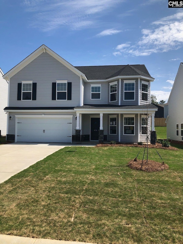 view of front of home with a garage and a front yard