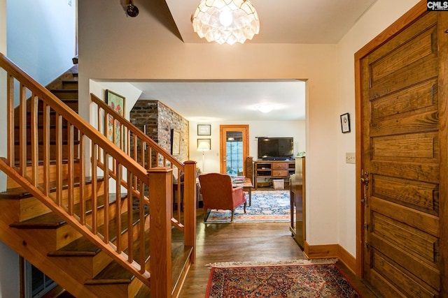 entrance foyer featuring dark hardwood / wood-style floors and a chandelier