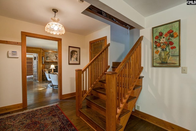 stairs with hardwood / wood-style flooring