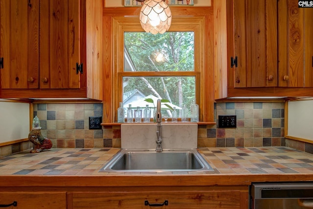 kitchen with sink, backsplash, and tile counters