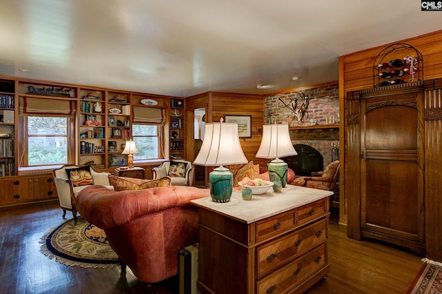 living room with a brick fireplace, dark hardwood / wood-style floors, and wooden walls