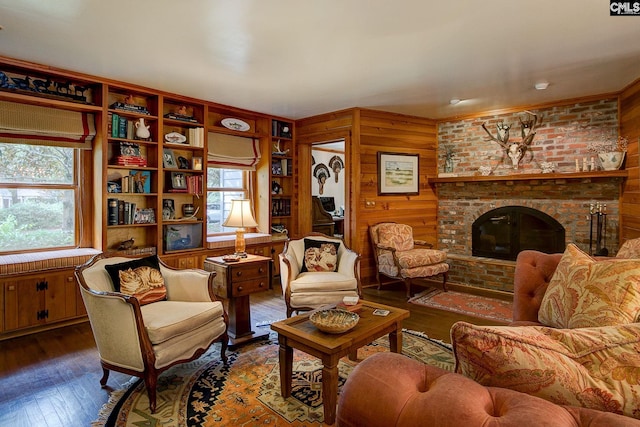 living room featuring wooden walls, a fireplace, and hardwood / wood-style floors