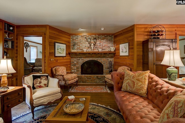 living room featuring wood-type flooring, a fireplace, and wood walls