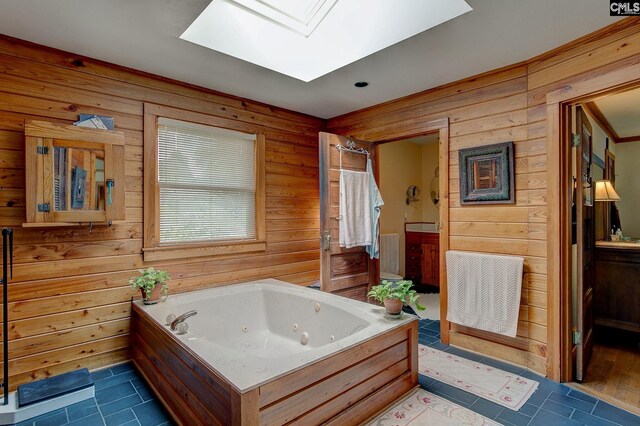 bathroom with independent shower and bath, tile patterned flooring, wooden walls, and a skylight