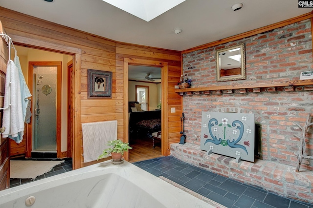 bathroom with a bathtub, wood walls, wood-type flooring, ceiling fan, and a skylight