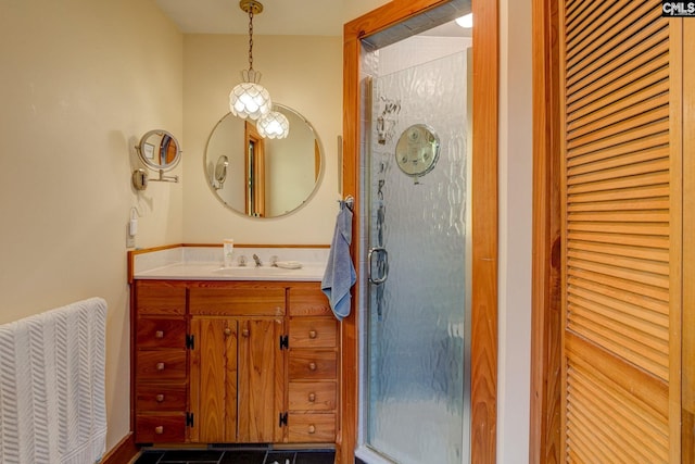 bathroom featuring tile patterned flooring, vanity, and a shower with door