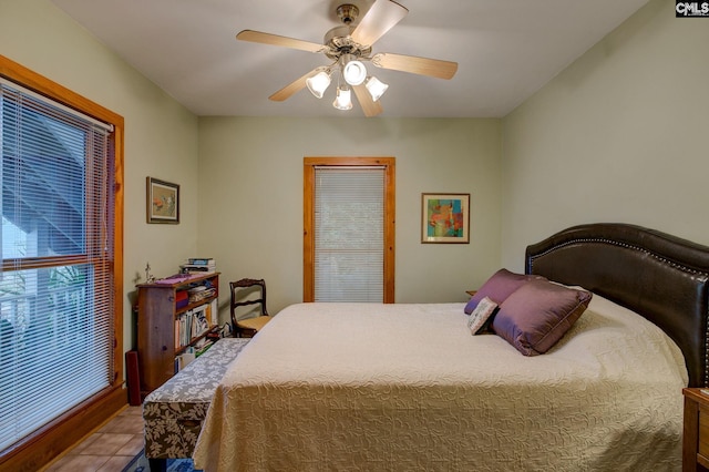 tiled bedroom with ceiling fan