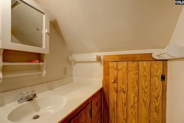 bathroom featuring lofted ceiling and vanity