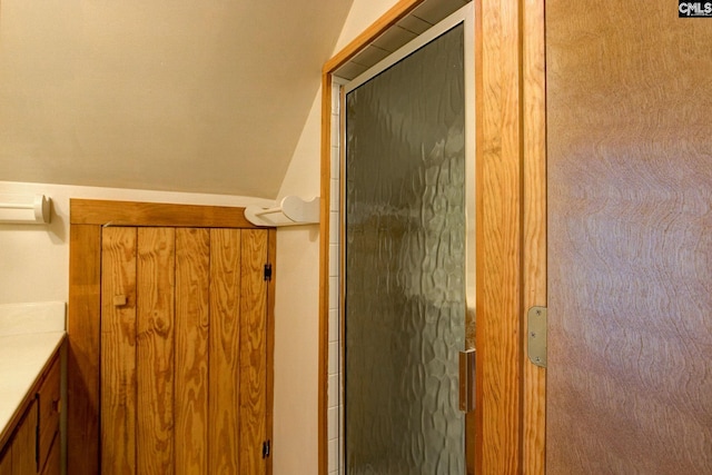 bathroom featuring walk in shower and vanity