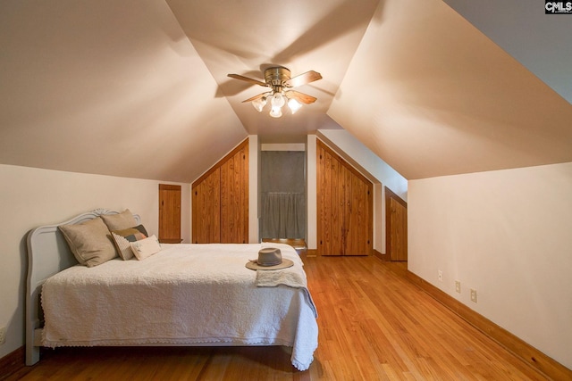 bedroom with ceiling fan, light hardwood / wood-style flooring, and vaulted ceiling