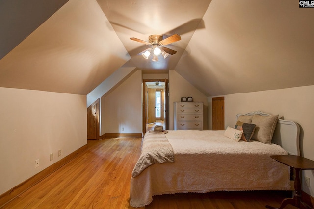 unfurnished bedroom featuring light wood-type flooring, lofted ceiling, and ceiling fan