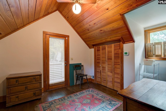 interior space with wood ceiling, vaulted ceiling, dark wood-type flooring, and ceiling fan