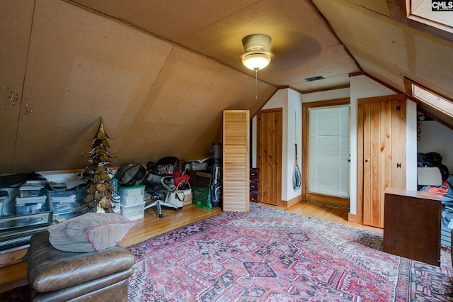 additional living space with ceiling fan, light wood-type flooring, and lofted ceiling