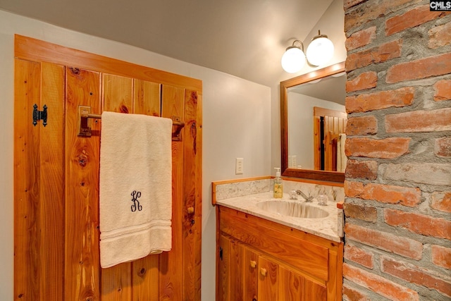 bathroom with vaulted ceiling and vanity