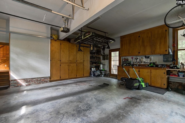 garage with a garage door opener and a workshop area