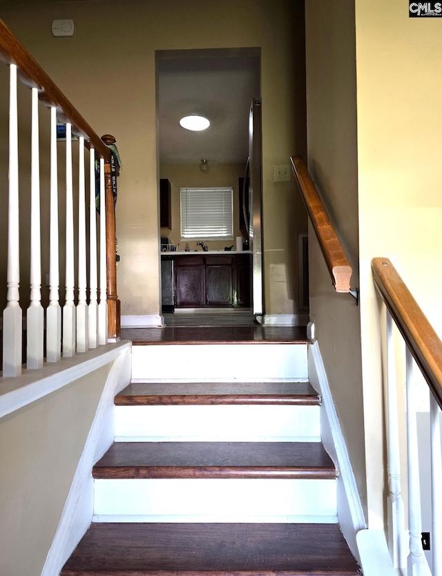 stairway featuring hardwood / wood-style flooring