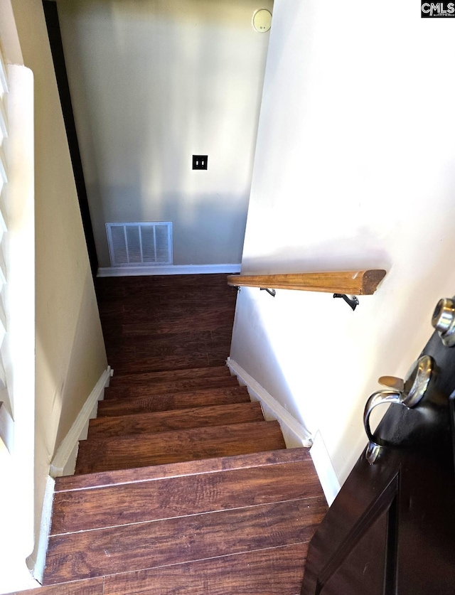 stairs featuring hardwood / wood-style floors