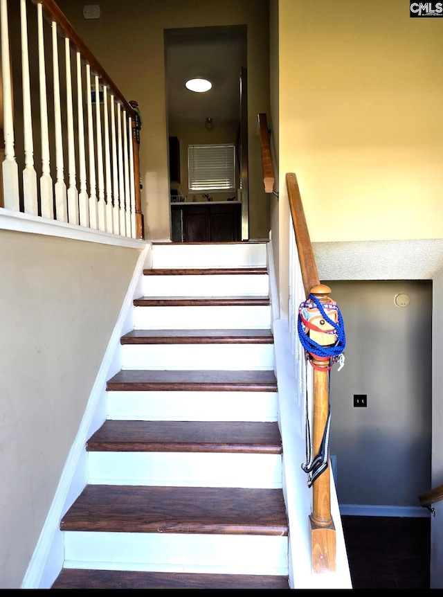 stairs featuring wood-type flooring