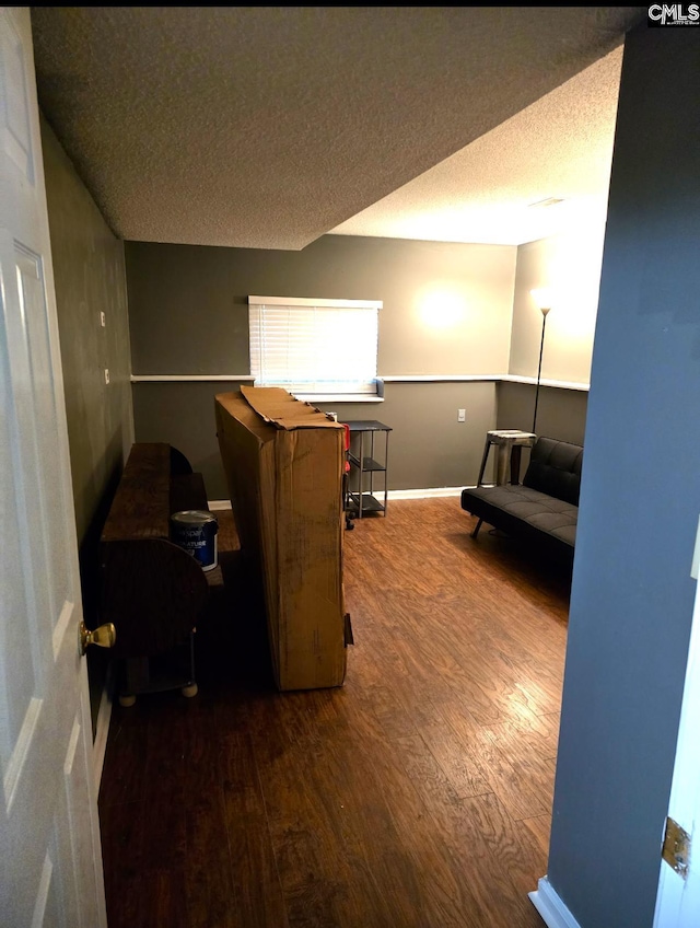 office featuring a textured ceiling and dark hardwood / wood-style flooring