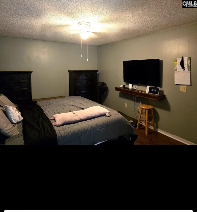 bedroom featuring a textured ceiling and hardwood / wood-style floors