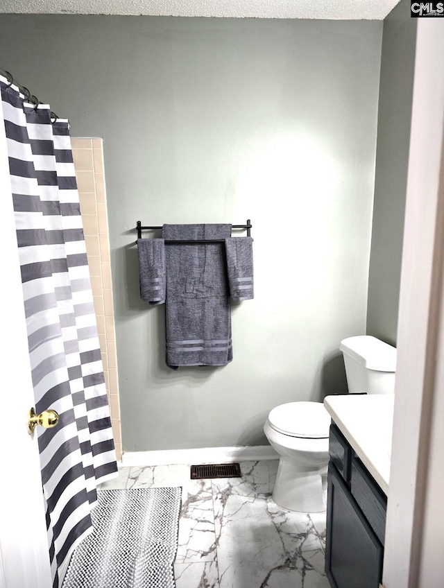 bathroom featuring vanity, toilet, a textured ceiling, and curtained shower