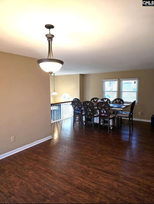 dining space with dark hardwood / wood-style flooring