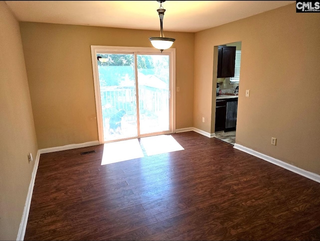 empty room with dark hardwood / wood-style flooring