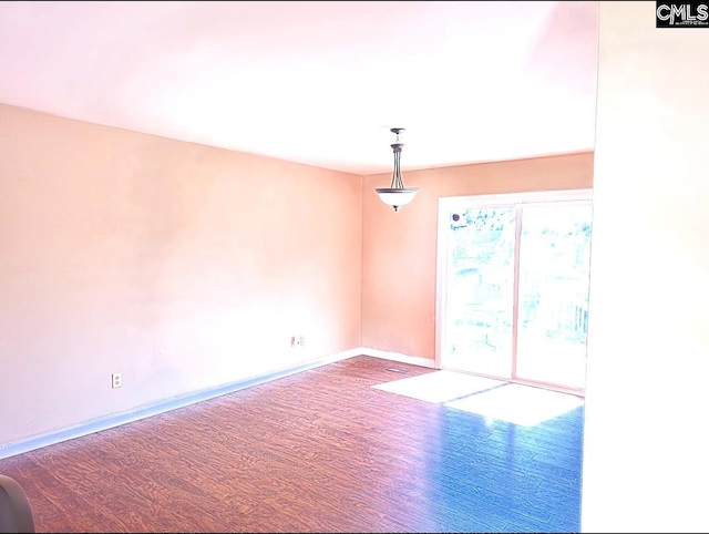 spare room with hardwood / wood-style floors