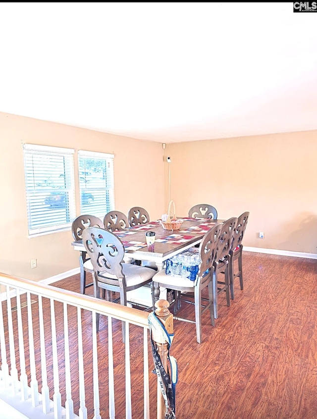 dining space with wood-type flooring