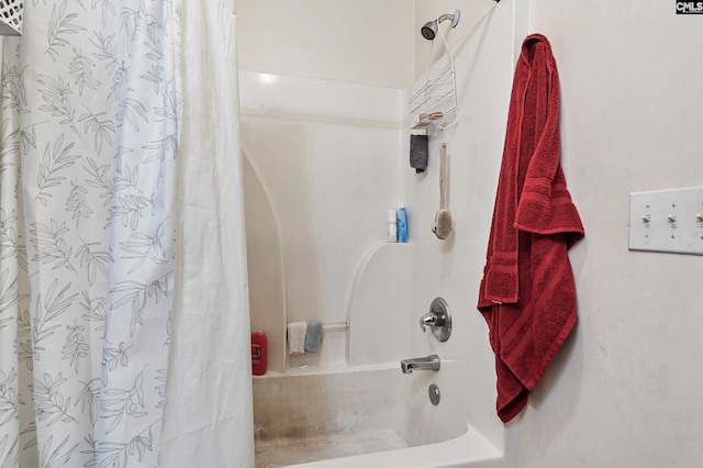 bathroom with shower / bath combo with shower curtain