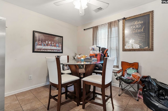 tiled dining area with ceiling fan