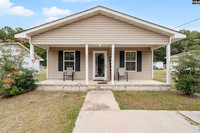 bungalow-style home with a front lawn and covered porch