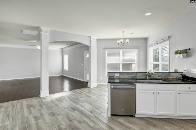 kitchen featuring white cabinetry, pendant lighting, light hardwood / wood-style flooring, stainless steel dishwasher, and sink