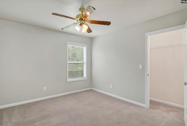 spare room featuring ceiling fan and light colored carpet