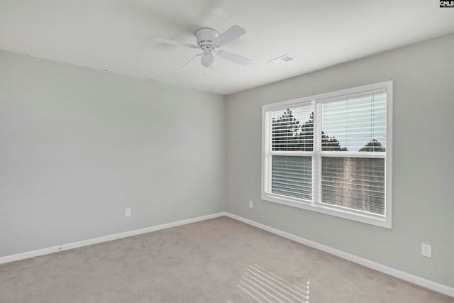 unfurnished room with ceiling fan and light colored carpet