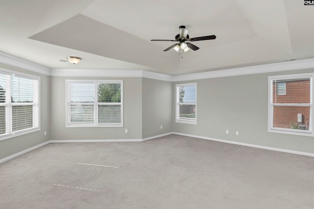 carpeted empty room featuring a tray ceiling and ceiling fan