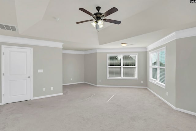 spare room featuring ceiling fan, light colored carpet, and crown molding