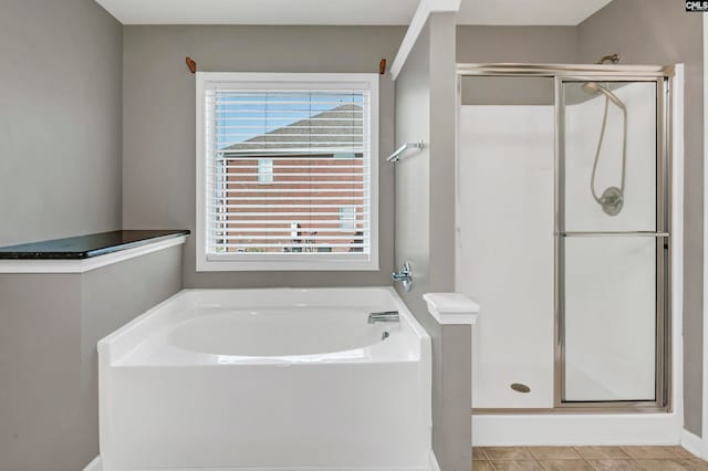 bathroom featuring tile patterned flooring and plus walk in shower