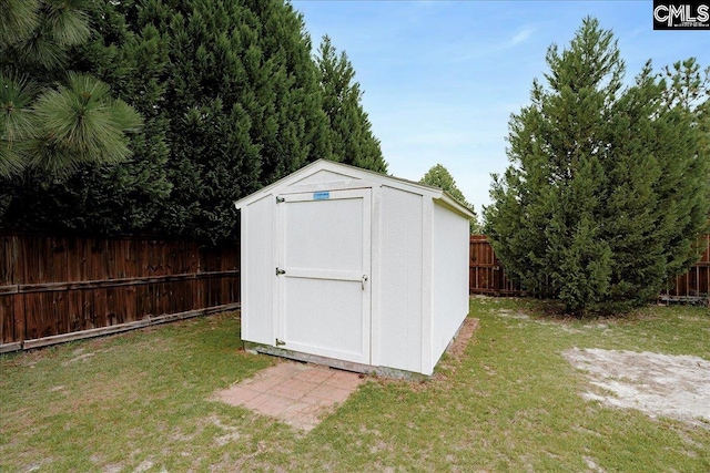 view of outbuilding featuring a lawn