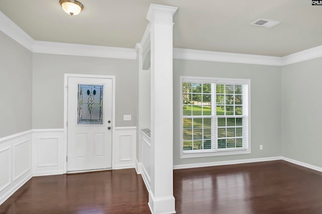 entryway with ornamental molding and dark hardwood / wood-style floors