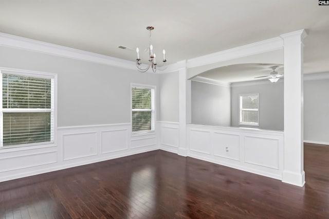 empty room with ceiling fan with notable chandelier, ornamental molding, dark hardwood / wood-style floors, and plenty of natural light