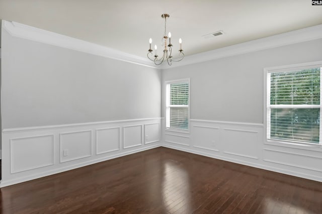 unfurnished room with a healthy amount of sunlight, ornamental molding, and dark wood-type flooring