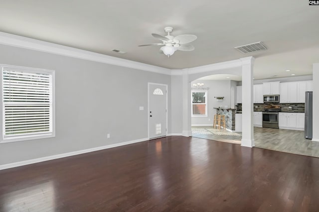 unfurnished living room with ornamental molding, wood-type flooring, and ceiling fan