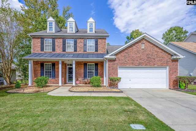 view of front facade featuring covered porch, a front yard, and a garage