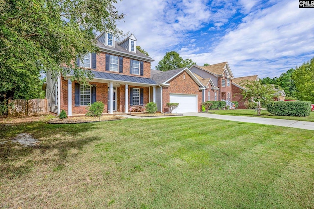 colonial inspired home with a front yard, a garage, and covered porch